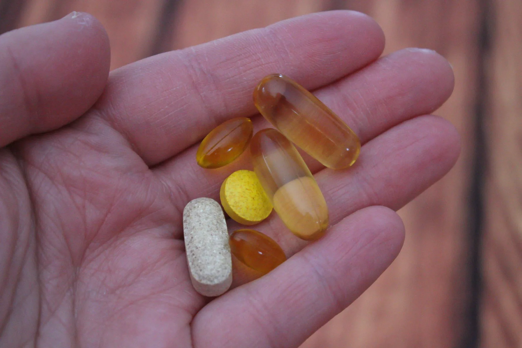 A handful of unbranded vitamin tablets and capsules