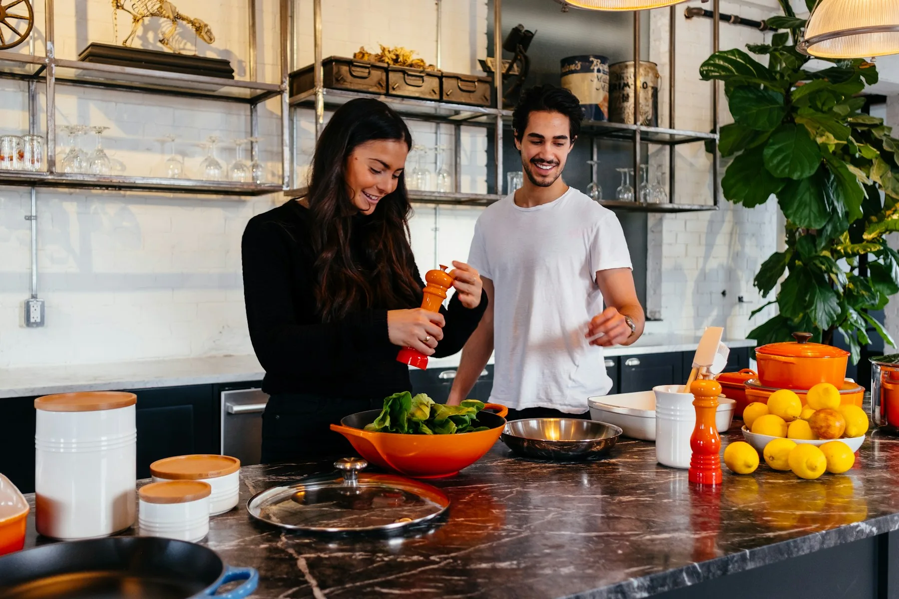 Two people preparing food together in a kitchen